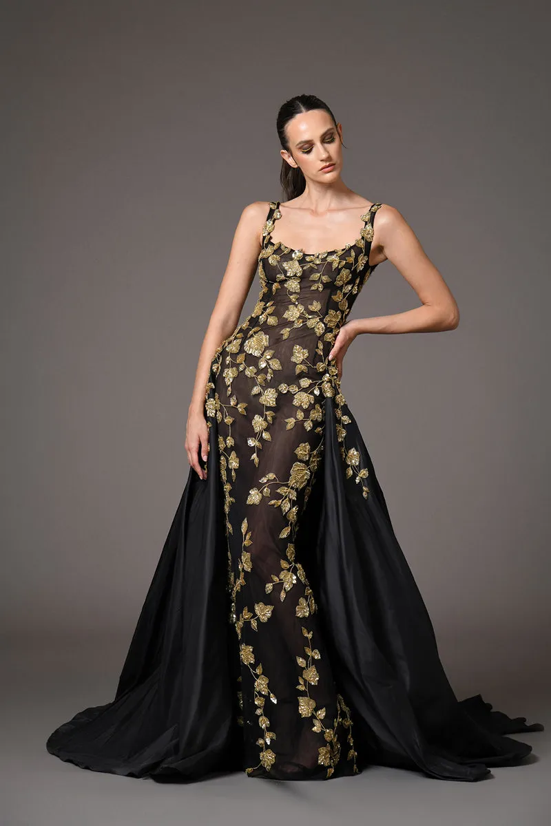 Black tulle dress adorned with intricate gold embroidery with a dramatic black silk taffeta overskirt