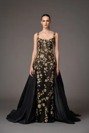 Black tulle dress adorned with intricate gold embroidery with a dramatic black silk taffeta overskirt