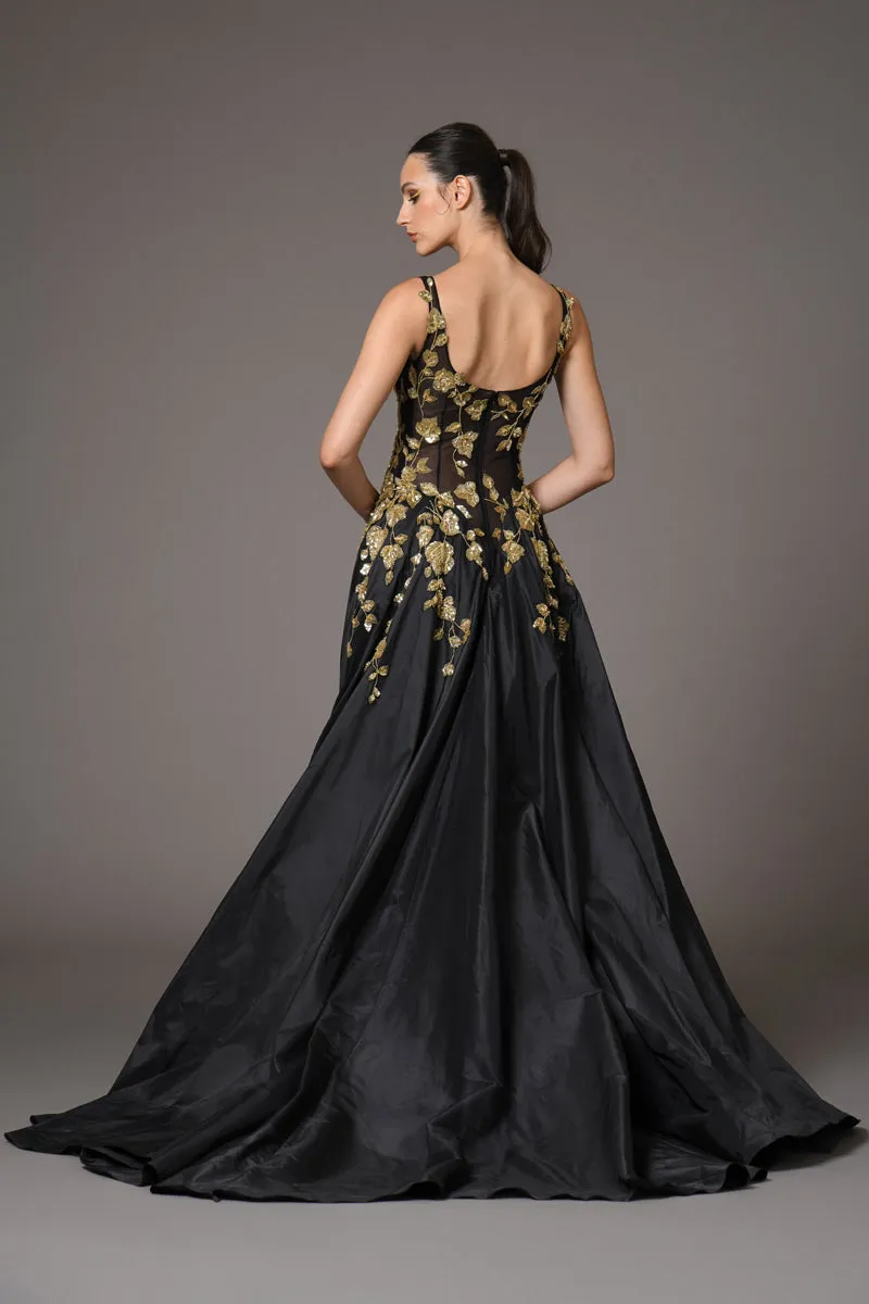 Black tulle dress adorned with intricate gold embroidery with a dramatic black silk taffeta overskirt