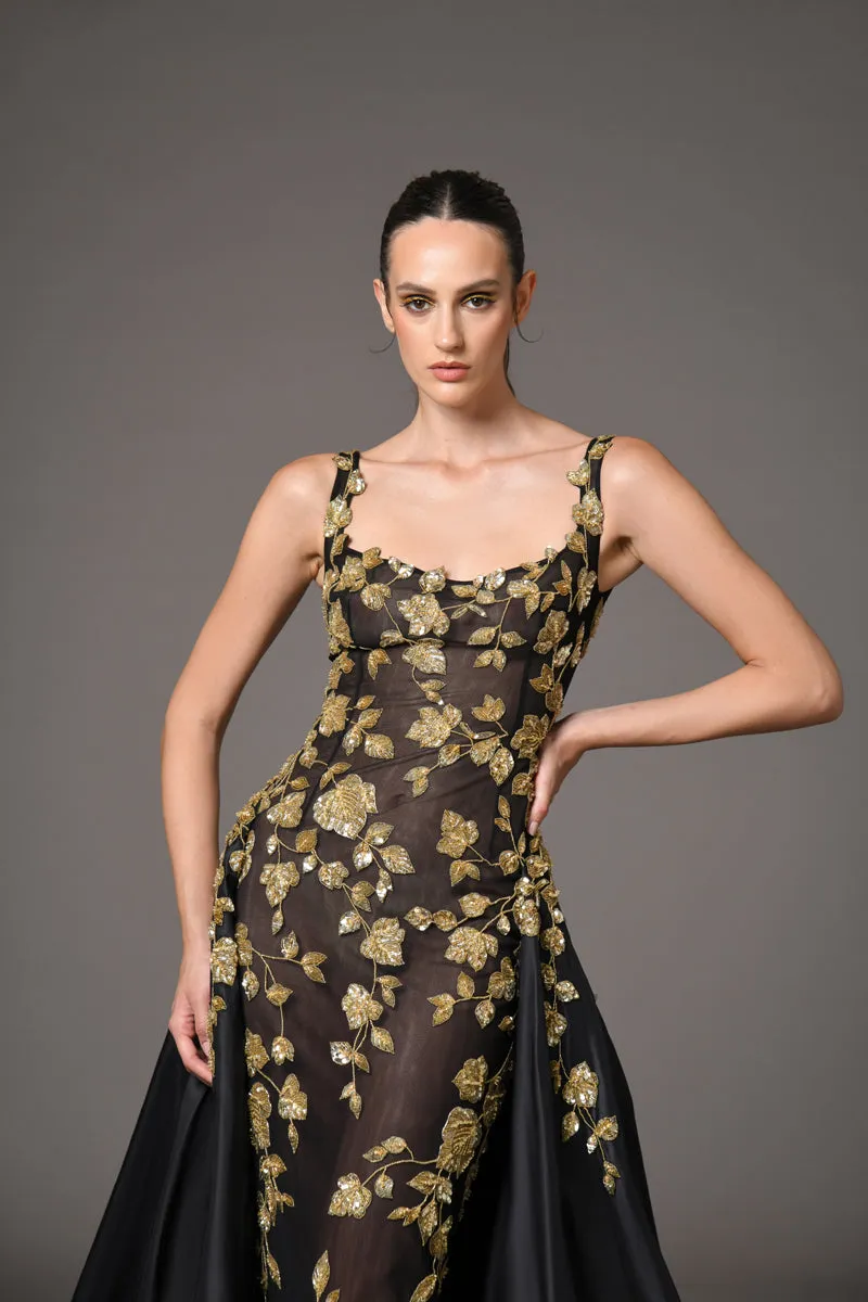 Black tulle dress adorned with intricate gold embroidery with a dramatic black silk taffeta overskirt