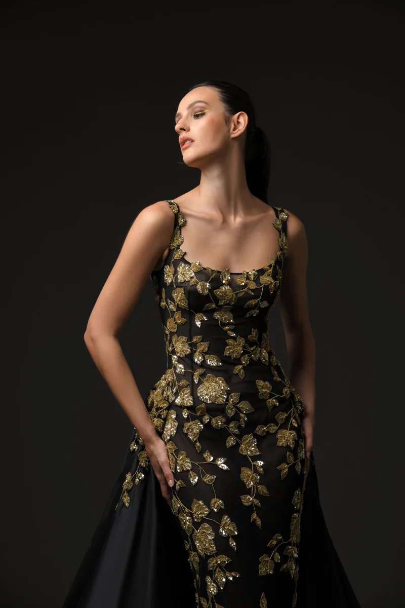 Black tulle dress adorned with intricate gold embroidery with a dramatic black silk taffeta overskirt