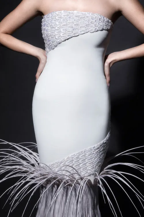 Strapless white silk crêpe gown with dramatic breakout mermaid tail in rippling silk organza, adorned with mermaid scales in 3D raffia threadwork, pearls and crystals